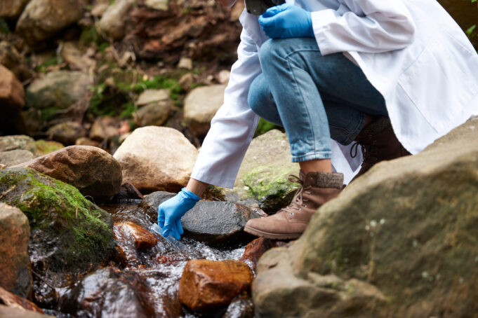 Analyst testing for PFAS in river